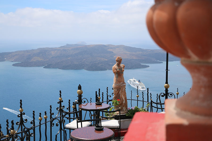 Classical statue overlooking Santorini caldera