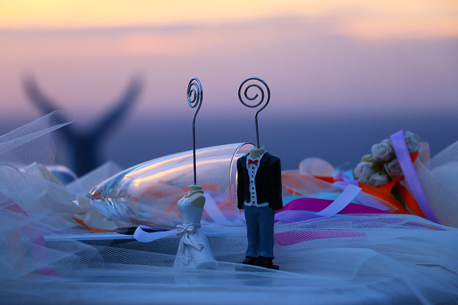 Wedding figurines at sunset
